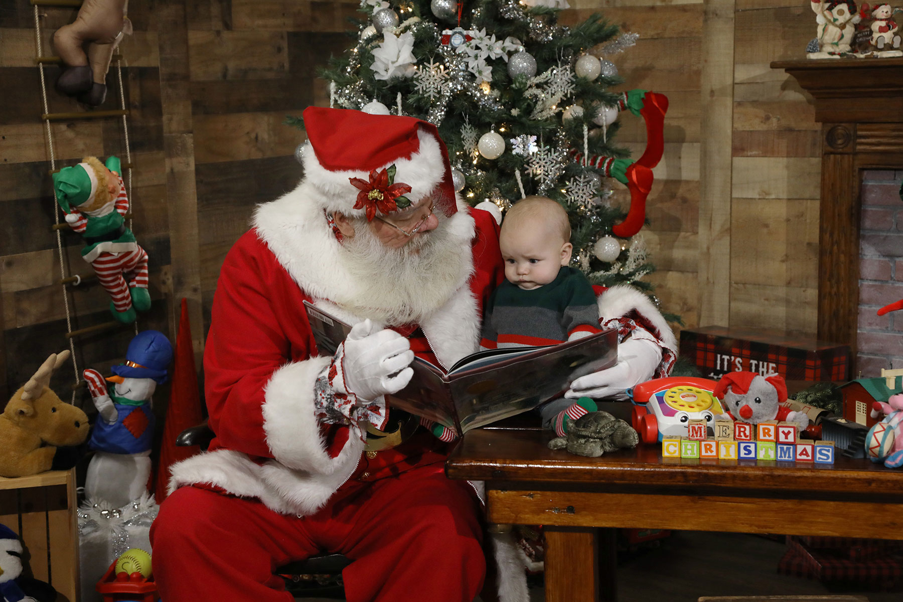 Santa reading to a baby boy