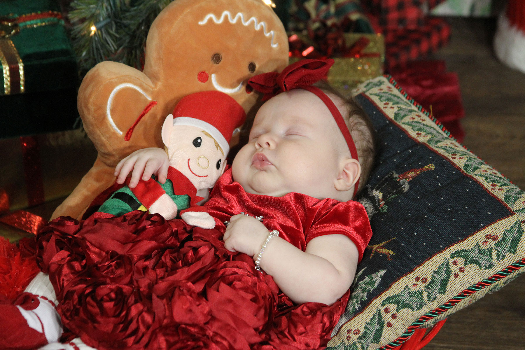 sleeping christmas baby with elf and gingerbread man toys