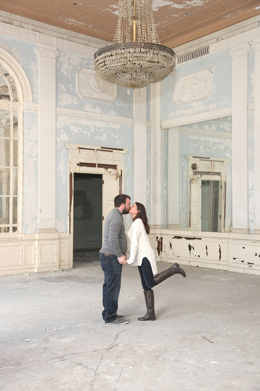 engaged couple kissing in the old ballroom at The Commodore Perry building in downtown Toledo across from Fifth Field Park