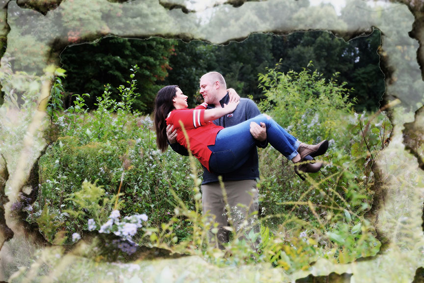 groom to be carrying the bride to be in a field at Wildwood Preserve MetroPark