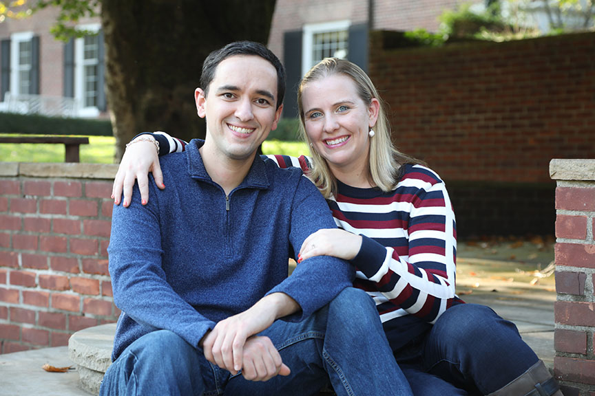 young couple sitting on the steps near the Manor House garden at Wildwood Preserve metropark and posing for their engagement session